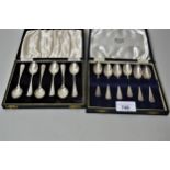 Two cased sets of six silver coffee spoons