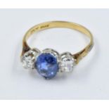 18ct Gold and platinum three stone sapphire and diamond ring, the central sapphire approximately 8mm