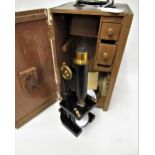 R & J Beck, black japanned brass monocular microscope, in a mahogany case with accessories