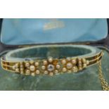 15ct Gold bangle of pierced floral design set with a single diamond and multiple split pearls (one