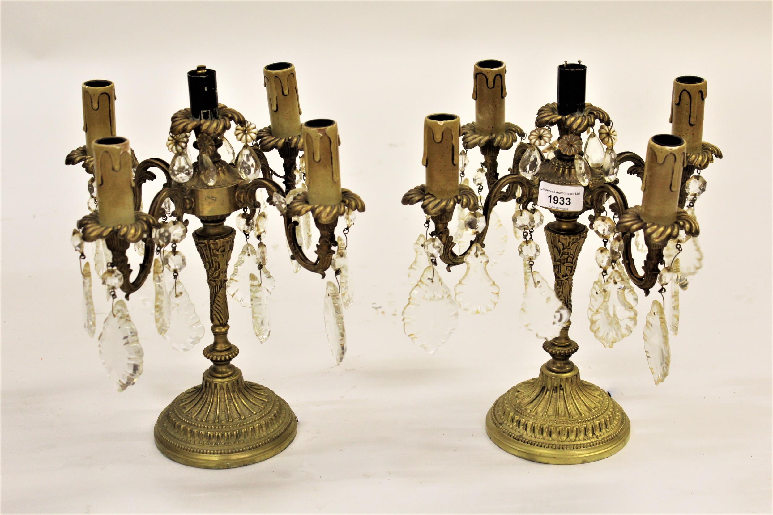 Pair of gilt brass four branch candelabra with cut glass drops and circular bases