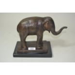 20th Century brown patinated bronze figure of an elephant, 8ins high