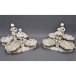 Set of four Derby white glazed porcelain figural sweetmeat baskets (blue mark), each 10ins wide