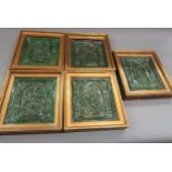 Group of four 16th Century German green glazed pottery stove tiles decorated in high relief, each