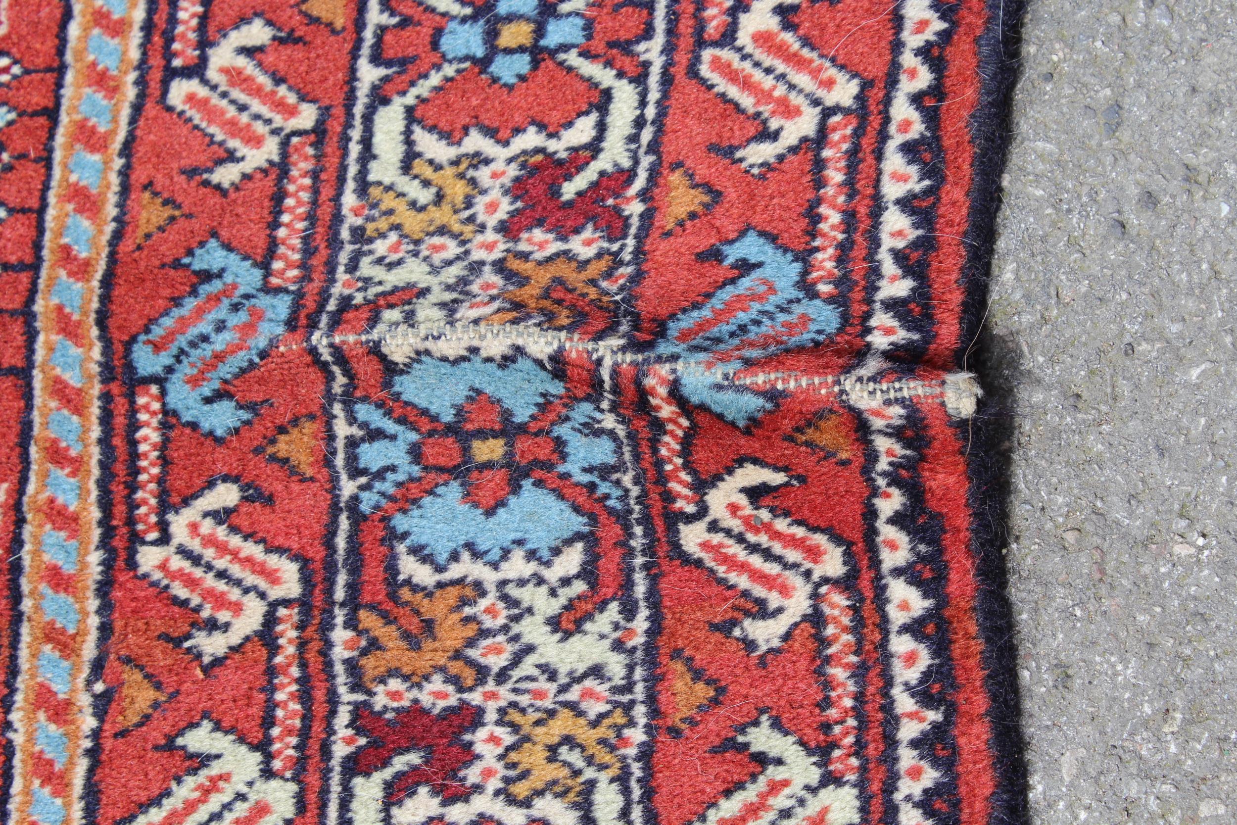 Indo Persian runner of Afghan design with a repeating hooked medallion pattern, on a rose ground - Image 3 of 6