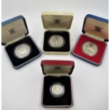 Four various silver proof coins comprising three crowns and a one pound