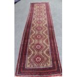 Afghan runner with a multiple hooked medallion design on a beige ground with borders, 11ft 3ins x