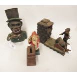 Group of three cast iron money banks in the form of an artillery gun, Father Christmas and a Negro