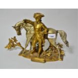 Gilt and silvered bronze figure of a man in 18th Century costume with a horse, 9ins high