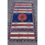 Unusual part Kelim and part piled rug with a medallion and banded design in shades of blue, claret