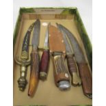 Four various hunting knives, a paper knife and a bread knife with horn handle