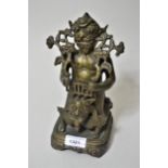 Tibetan dark patinated bronze in the form of a stylised figure riding an animal, on an integral