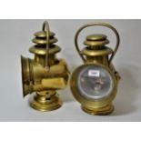 Pair of brass car lamps marked ' Orient Dietz ', 12.5ins high Glass to both are intact.