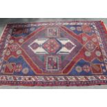 Afghan Belouch rug with centre medallion and multiple borders on a red ground, 84ins x 54ins