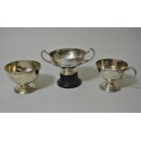 London silver two handled pedestal cup marked Harrods London, on ebonised stand, London silver