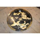 Chinese circular mother of pearl black lacquered panel, small Japanese carved wooden mirror, and a