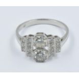 Art Deco style platinum and diamond set ring with a pair of central stones flanked by stepped