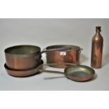 Four various copper cooking pans and a similar bottle