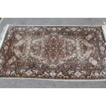 Small cotton Persian design rug with a medallion and all-over floral design on a pale blue ground,