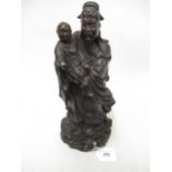 Chinese carved hardwood figure of an Immortal with child, 12ins high