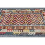 Kelim rug with an all-over stylised polychrome flower head design and triple borders, 8ft x 5ft 3ins
