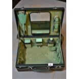 1930's Green leather dressing case, the hinged cover enclosing a fitted interior with original green