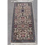 Small Tabriz floral pattern rug on beige ground, 54ins x 23ins