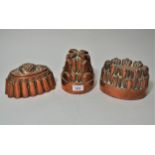 Group of three various 19th Century copper jelly moulds Holes and dents to circular one. Other two ,