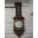 Late 19th / early 20th Century carved oak aneroid barometer thermometer by Negretti & Zambra, in