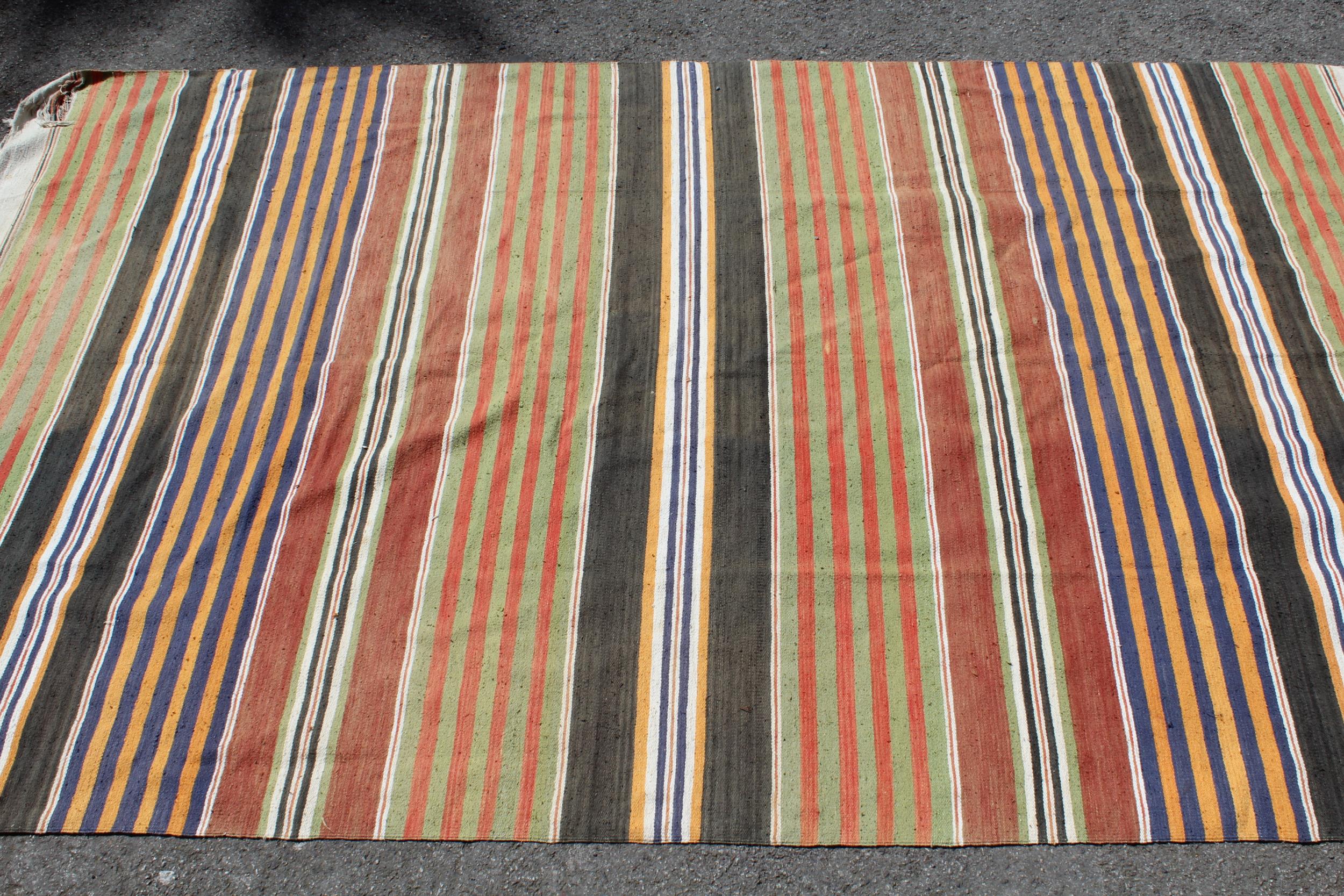 Two tribal rugs of multi colour striped design