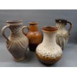 Three large German stoneware baluster form jug vases, together with a similar baluster vase, the