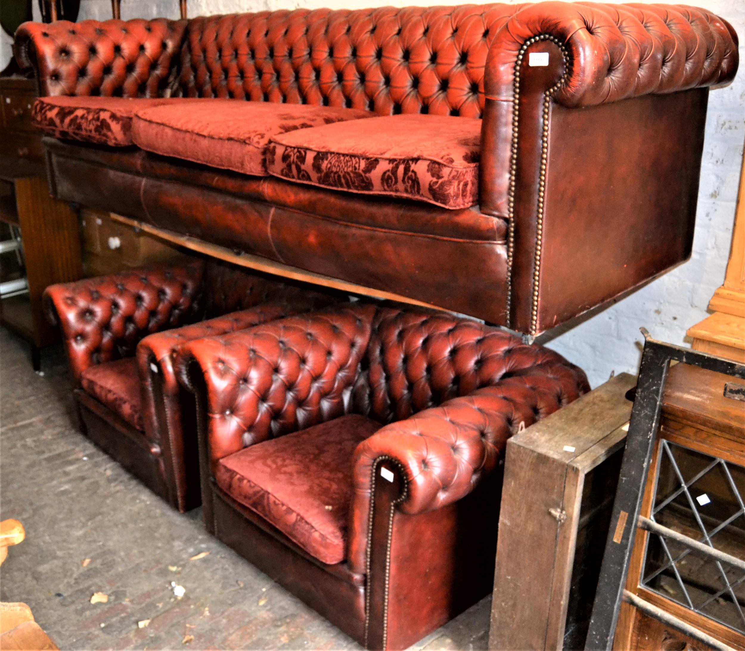 20th Century red leather upholstered Chesterfield three seat sofa, with pair of matching