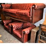 20th Century red leather upholstered Chesterfield three seat sofa, with pair of matching