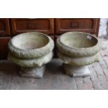 Pair of weathered cast concrete pedestal garden planters with lion mask relief decoration, 15ins