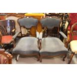 Pair of Edwardian mahogany open arm drawing room chairs with pierced splat and padded backs,