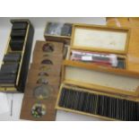 Four boxes of various magic lantern slides, including many coloured slides and a quantity of loose