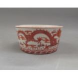 Small Chinese circular tapering bowl decorated with dragons in iron red, 4.25ins diameter In good