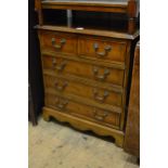 Small reproduction yew wood chest of two short and three long drawers on bracket feet