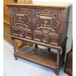 Early 20th Century oak cabinet on stand in Jacobean style, the moulded top above a pair of geometric