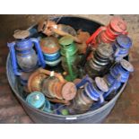 Quantity of various coloured metal paraffin lamps and four various brass oil lamps