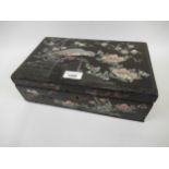 Late 19th Century Japanese lacquer and mother of pearl inlaid box, the hinged lid decorated with