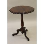 Victorian mahogany pedestal table with a shaped top and tripod base