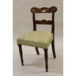 Set of six Regency mahogany dining chairs, the carved rail backs above overstuffed seats and