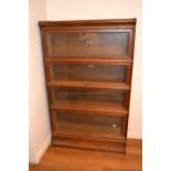 Globe Wernicke oak four section glazed bookcase, together with a similar mahogany three section