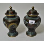 Pair of cloisonne baluster form vases decorated with dragons on a black ground, 8.75ins high