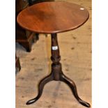 George III circular oak pedestal table with a turned column and tripod base, 17ins diameter