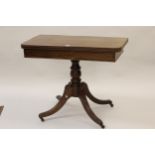 Regency mahogany fold-over card table on a turned column support with quadruped, 36ins wide