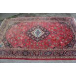Modern Kashan design rug with a lobed medallion and all-over floral pattern on a rose ground with