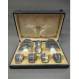 Cased set of six Royal Doulton blue and gilt decorated coffee cups and saucers of Art Deco design