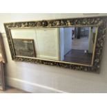 Reproduction carved gilded rectangular wall mirror with shell surmount, 25ins x 55ins